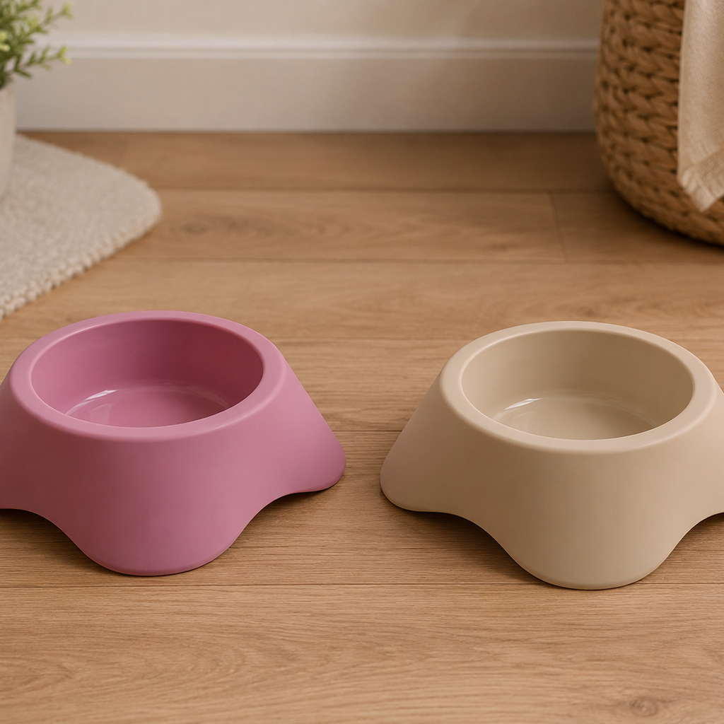 Deux gamelles MARTIN SELLIER pour petits chiens, disponibles en rose et beige, avec forme basse et base large, présentées dans un intérieur.