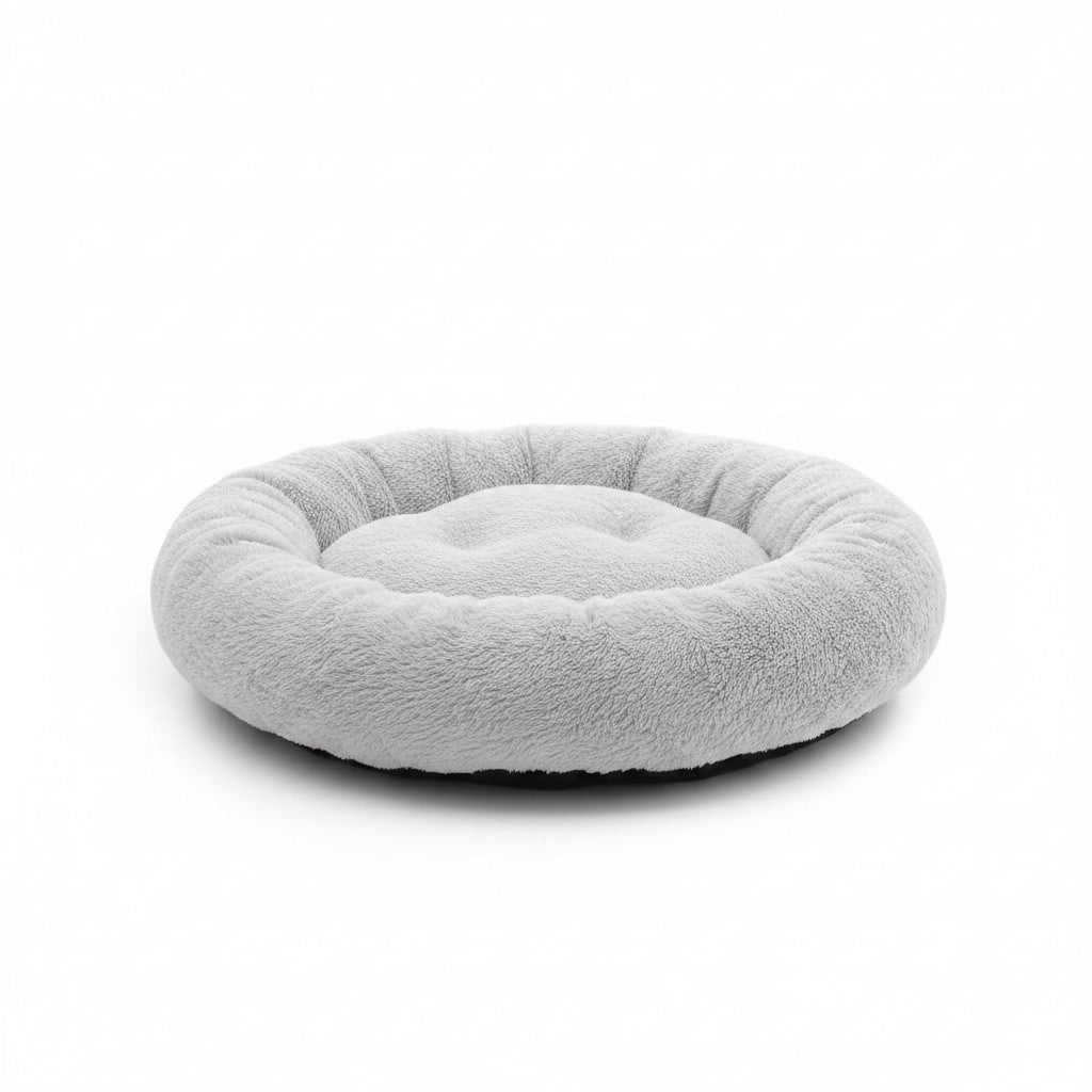 Lit rond gris clair pour petit chien avec coussin central moelleux et rebord épais rembourré.